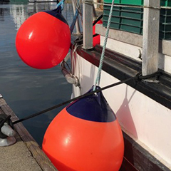 Details Of A Fishing Boat: Buoys With Red Flags And Fishing Net